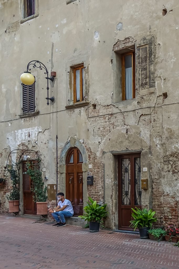 guy smoking on pavement in tuscan Village
